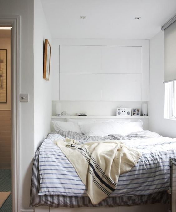 Small bedroom storage idea: use of picture ledge instead of a nightstand