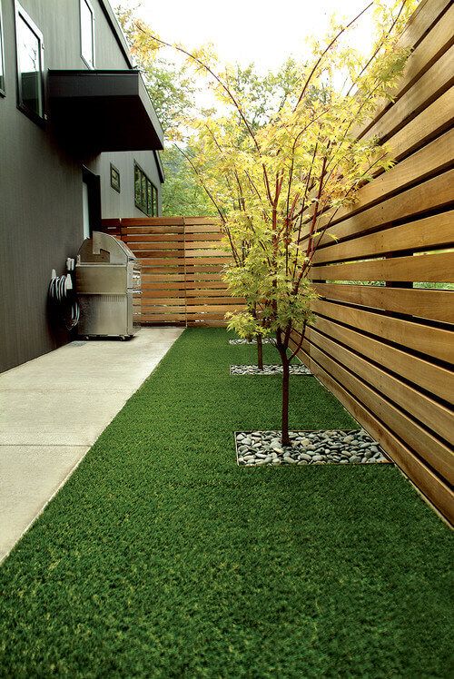 Contemporary courtyard garden with artificial grass and vertical slat fences