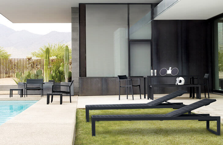 Contemporary outside space with artificial lawn and black outdoor furniture