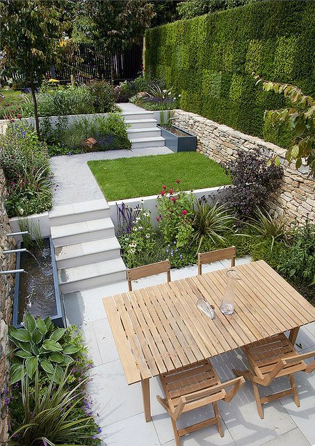 Contemporary tiered garden with artificial grass