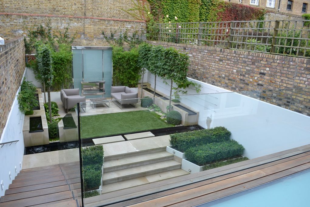 Contemporary tiered urban courtyard garden with artificial grass