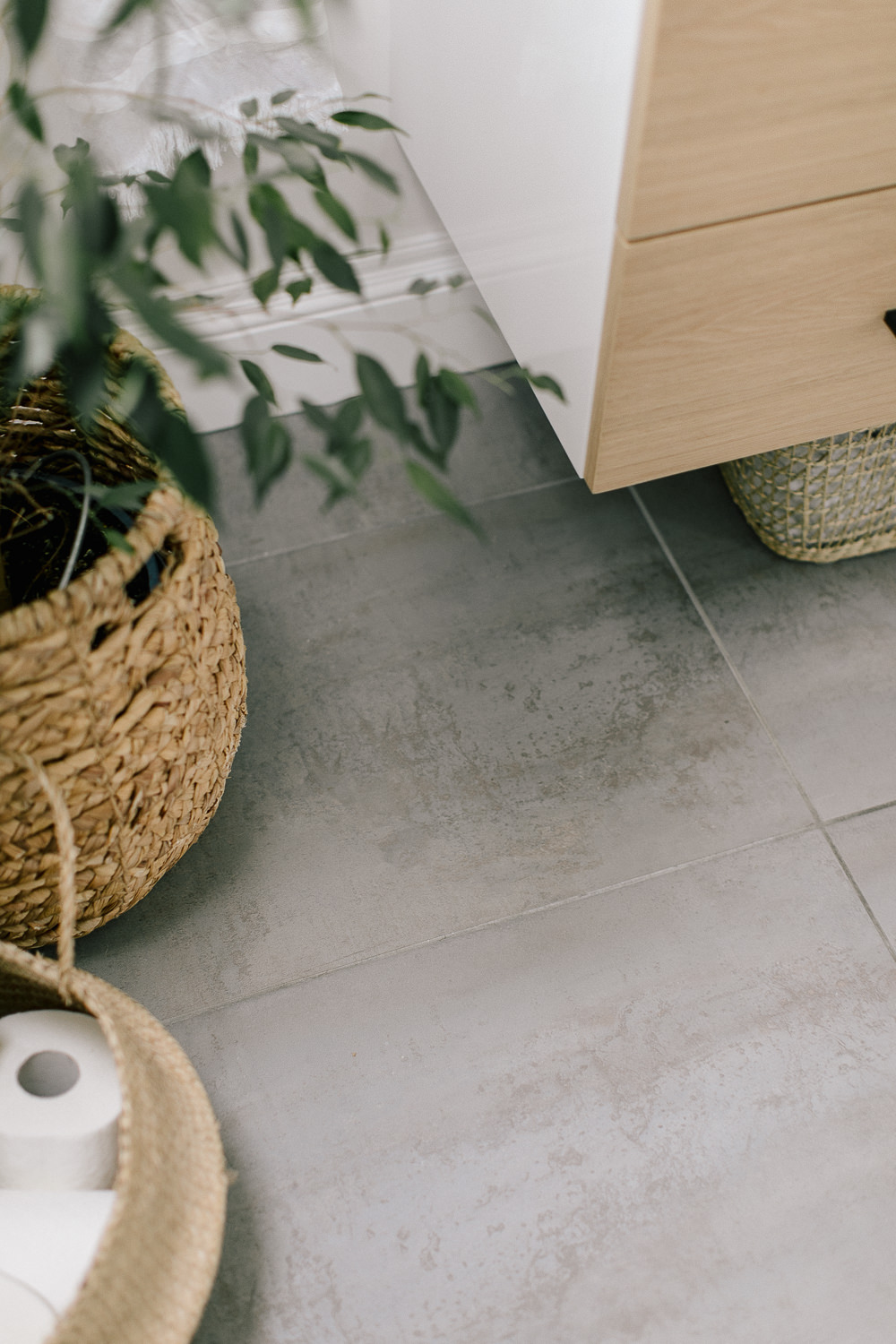 Grey Porcelanosa Floor Tiles | Rattan Bathroom Storage | Undercounter Bathroom Storage