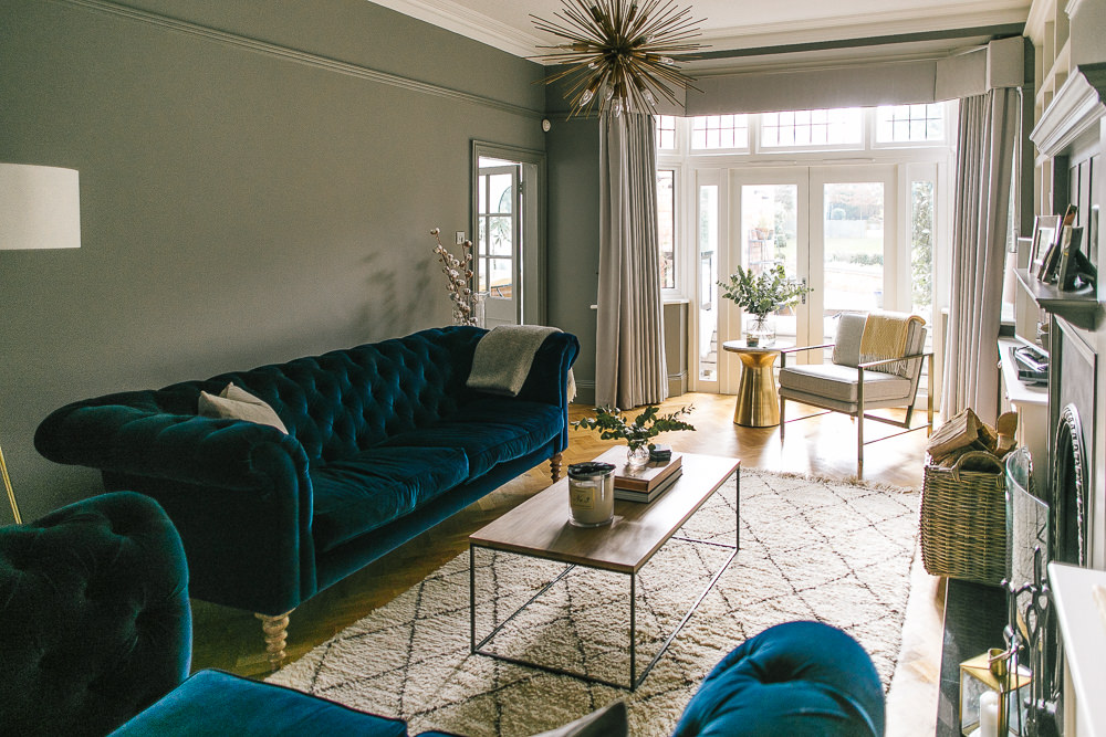 Deep blue velvet sofas in moody grey lounge