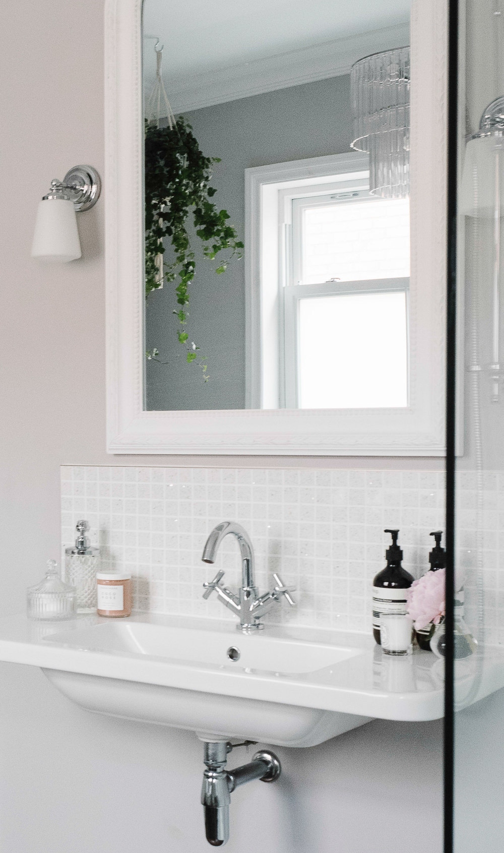 White mirror over wall mounted basin
