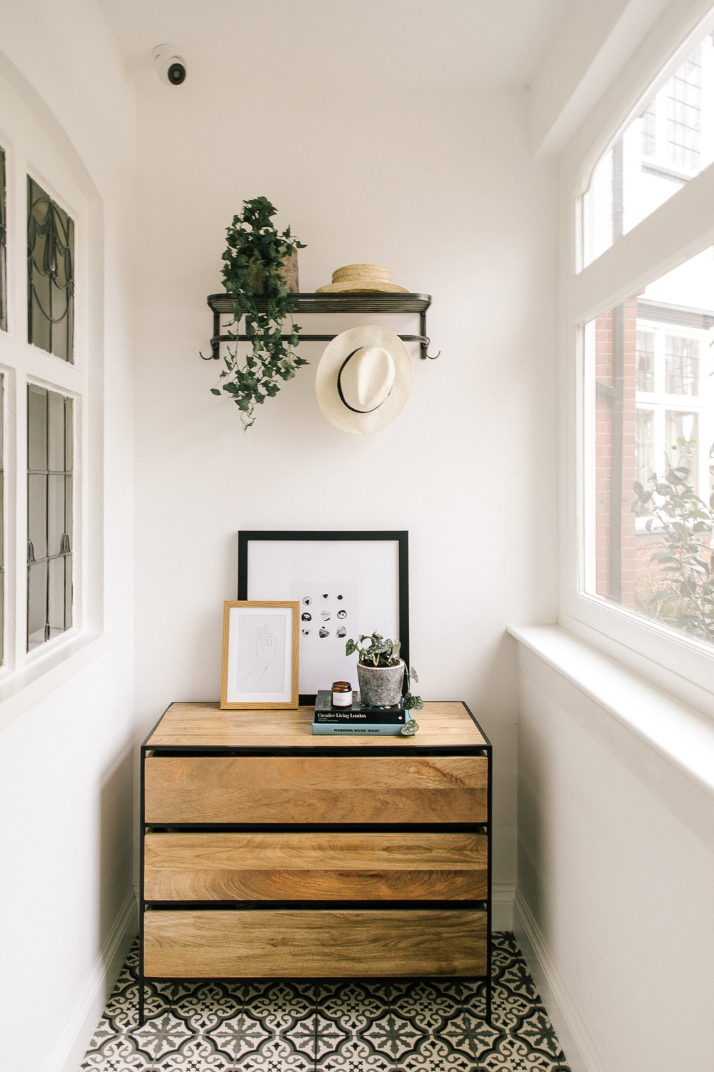 Light and bright porch with industrial style chest of drawers