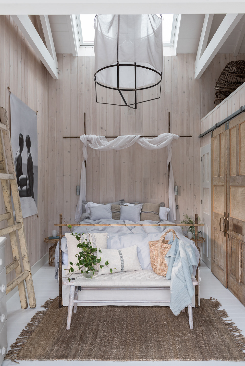 Organic boho style bedroom with wooden doors