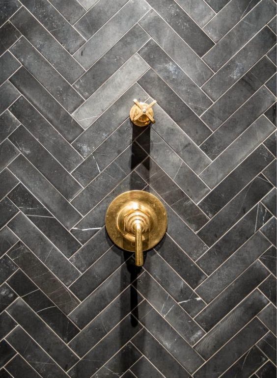 Dark grey herringbone bathroom tiles