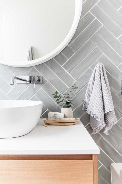 Light grey herringbone bathroom tiles