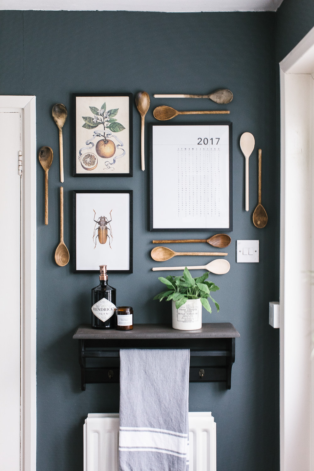 Gallery wall with art and wooden spoons