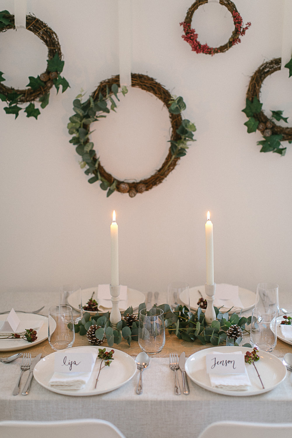 Candlelit Christmas tablescape with festive hanging branch