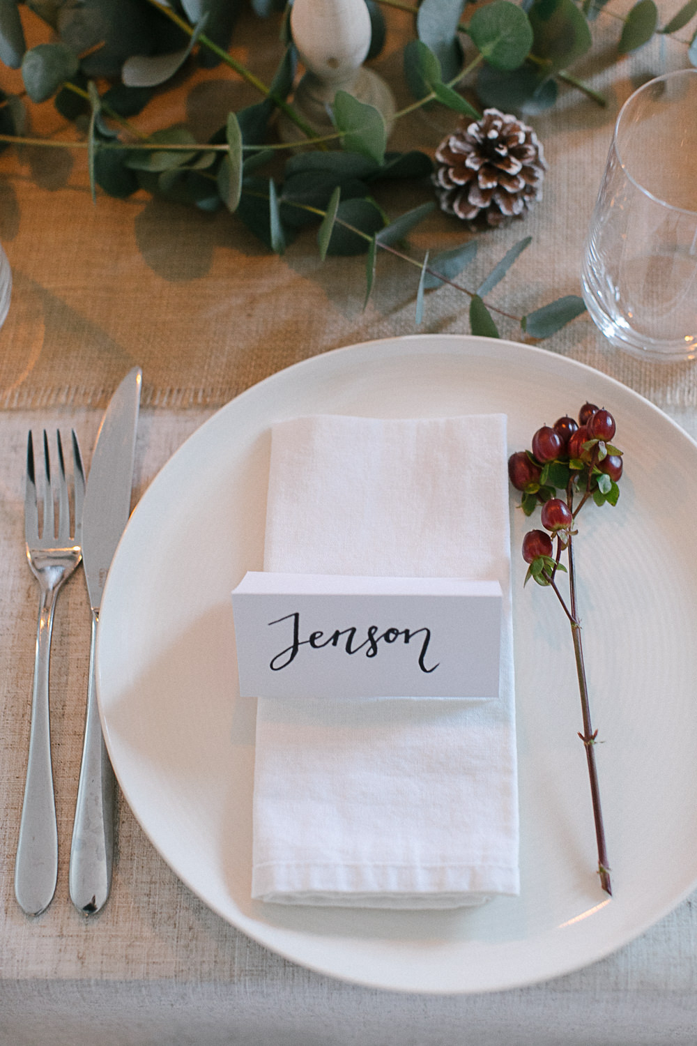 Festive tablescape with red berries and eucalyptus