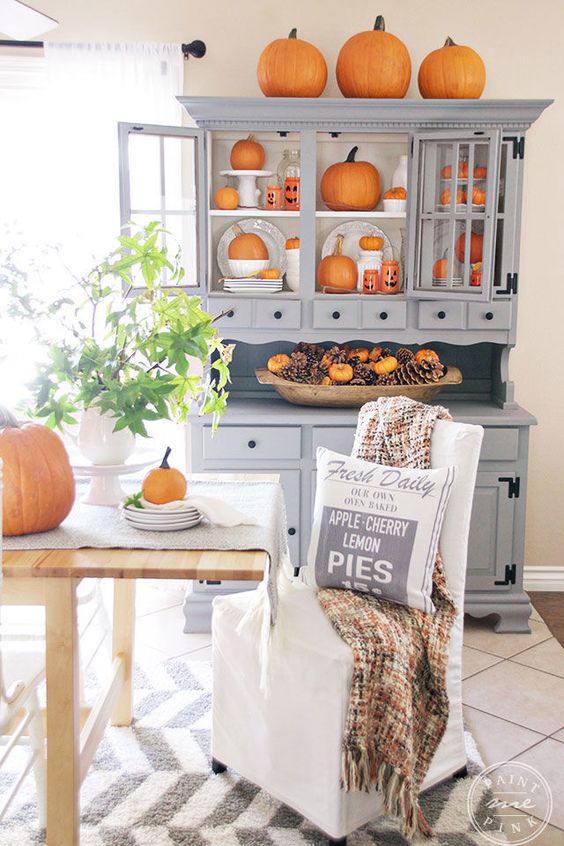 Pumpkins displayed in grey kitchen dresser