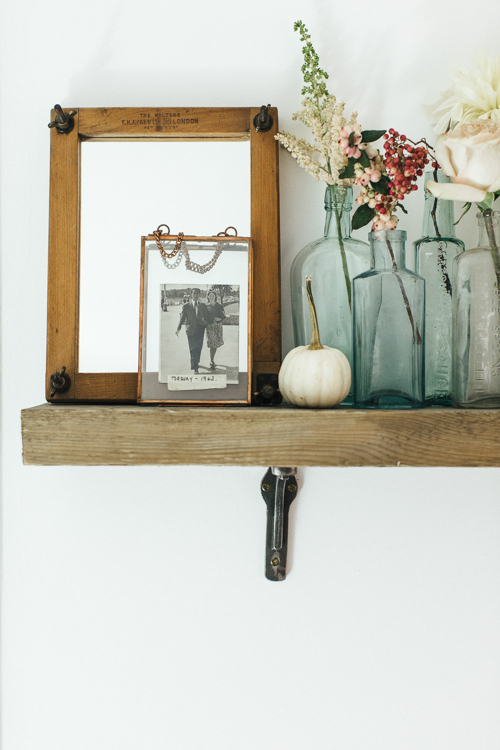 Vintage photo in copper frame on reclaimed wooden shelf