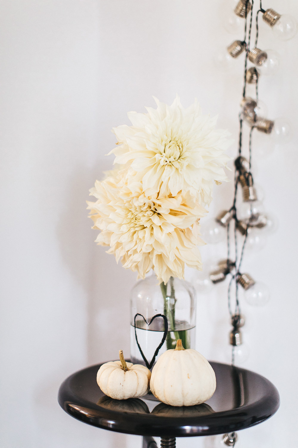 White dahlias in bottle vase