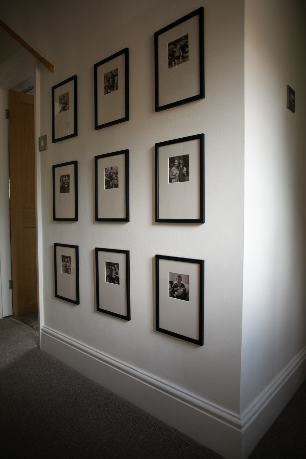 Grid Style Gallery Wall at top of stairs
