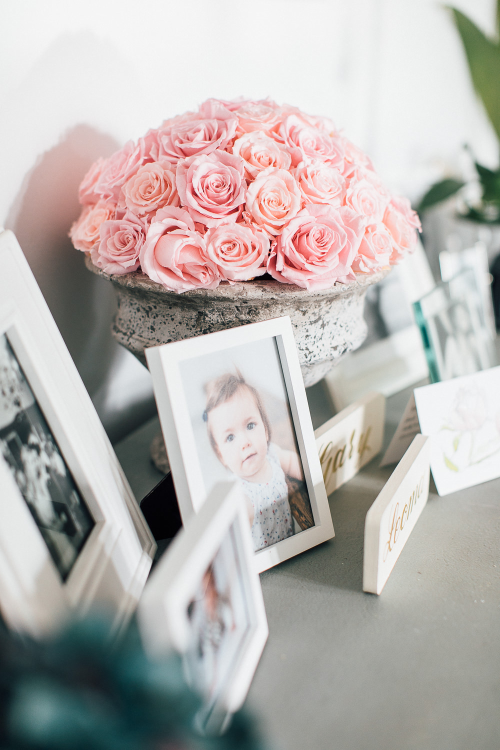 Roses on sideboard with frames