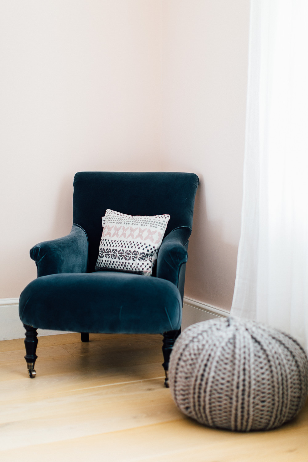 Statement velvet chair and grey pouffe
