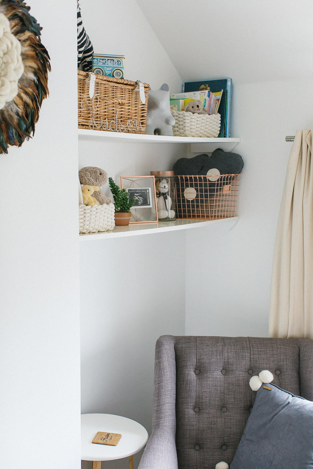 Grey, white and copper unisex nursery with small space storage solutions