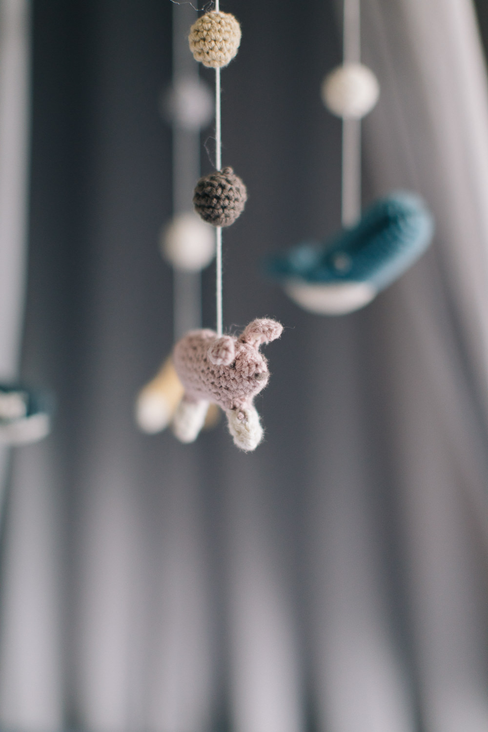 Grey canopy over cot with sebra arctic hand crocheted mobile