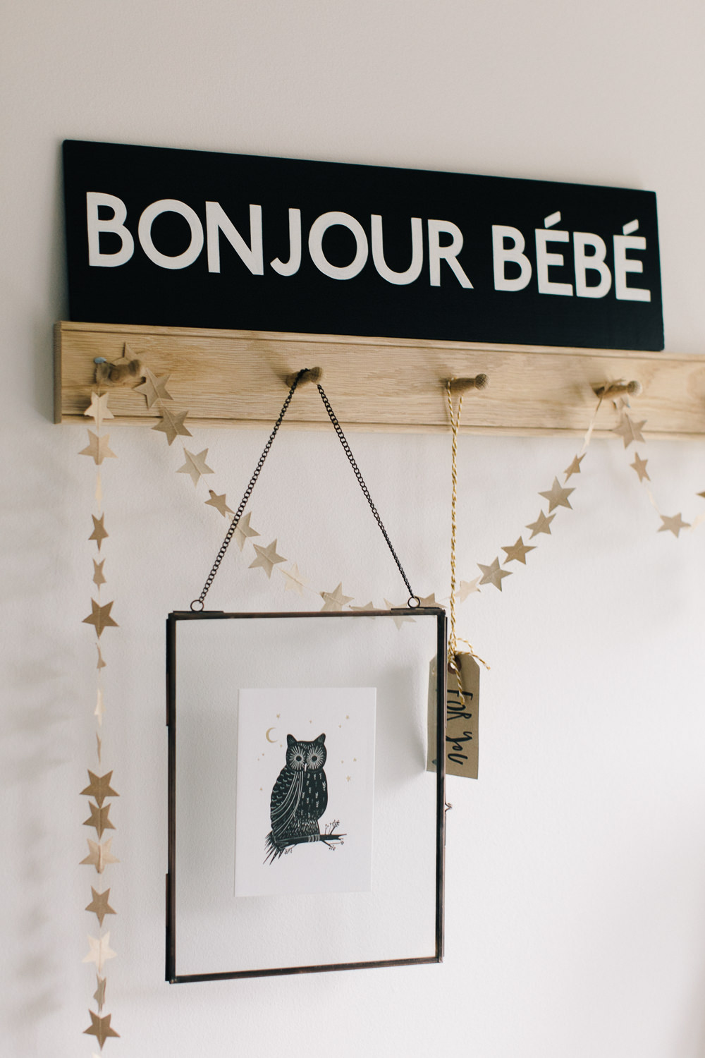 Oak peg rack with Bonjour Bebe sign and handmade star garland