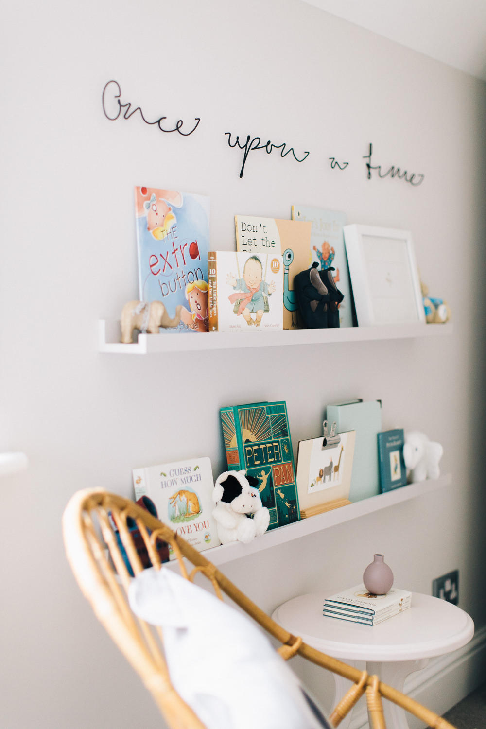 Ikea painted picture ledges with childrens books in a nursery with Once upon a tme sign