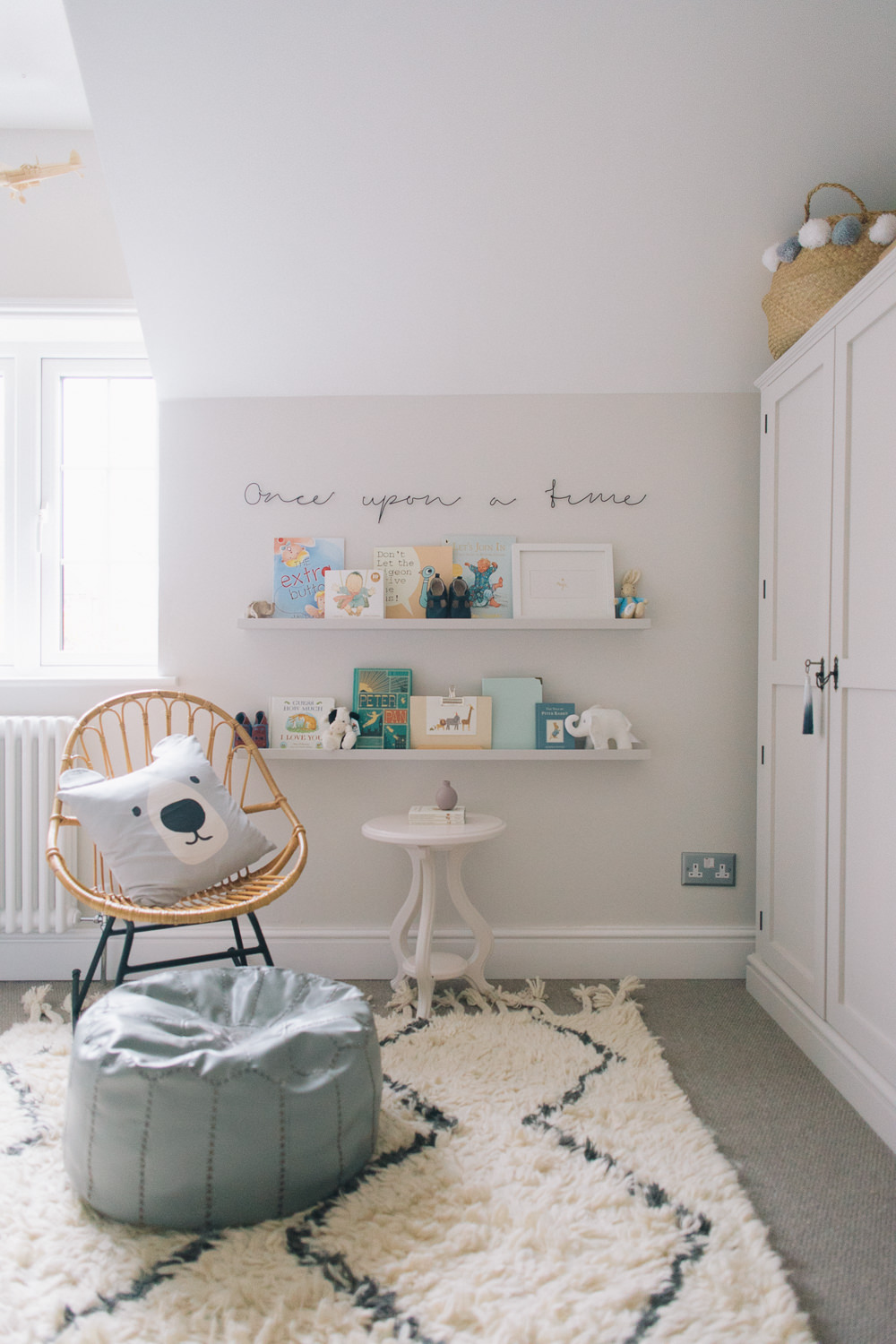Nursery reading corner with ikea painted ledges and once upon a time wire sign