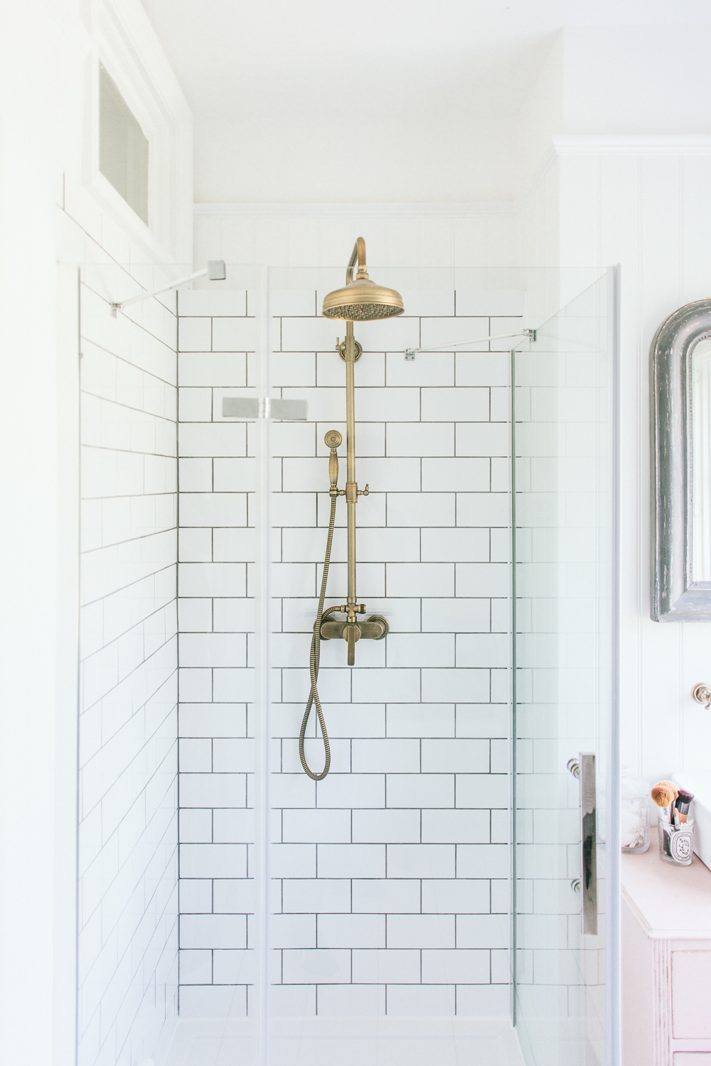 Antique brass shower head and metro tiles