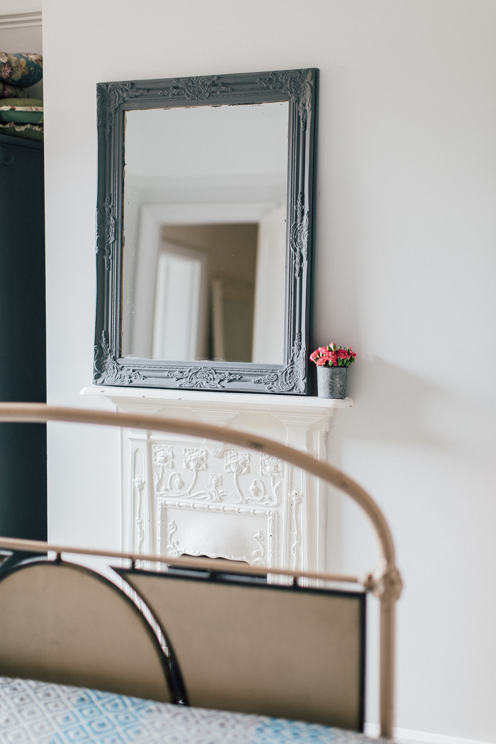 Mirror propped on antique fireplace