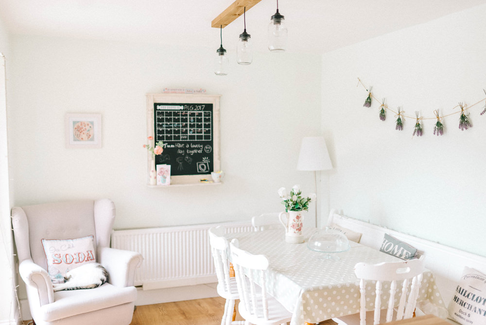 Chair, polka dot table and blackboard in a bright shabby chic kitchen