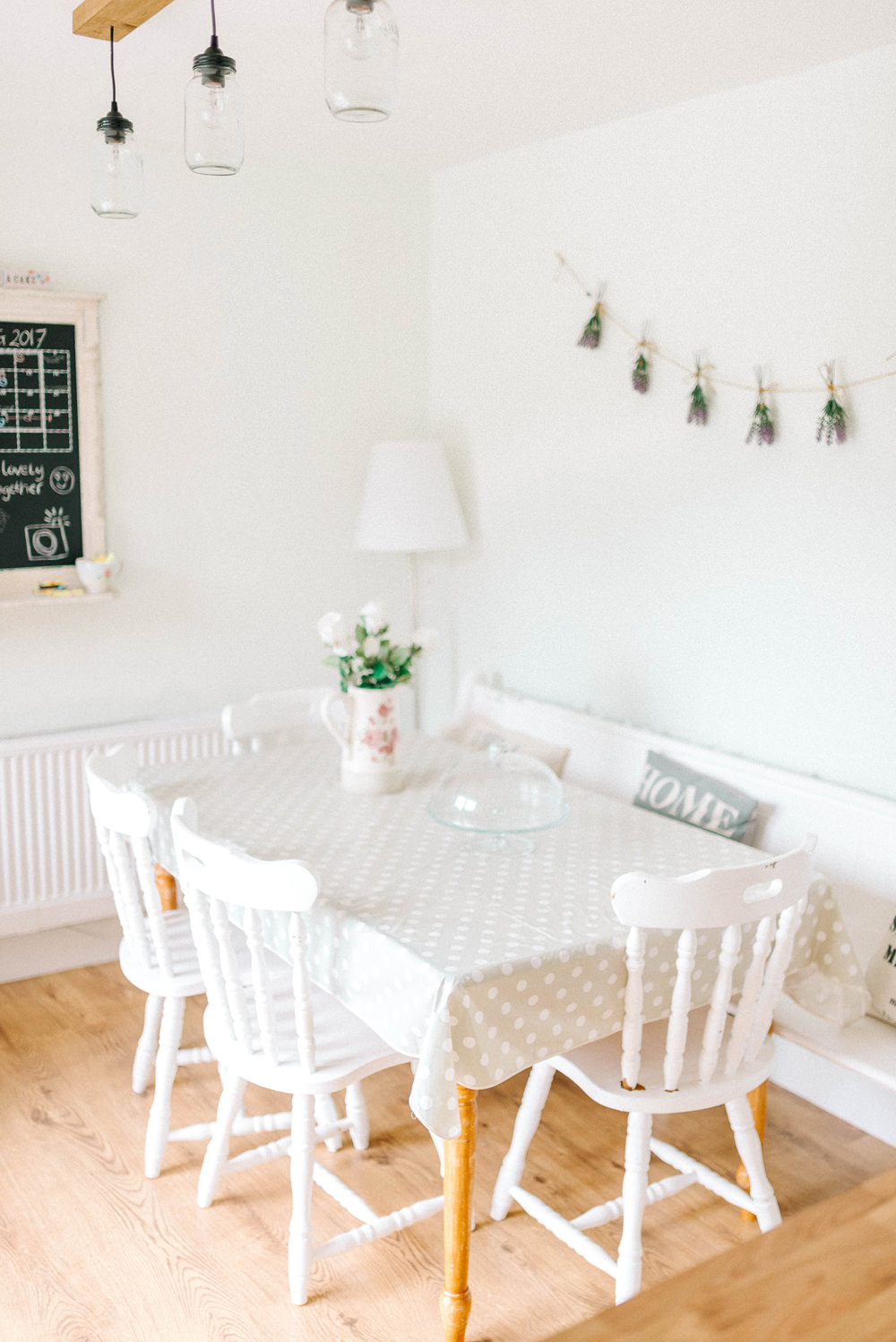 Chair, polka dot table and blackboard in a bright shabby chic kitchen