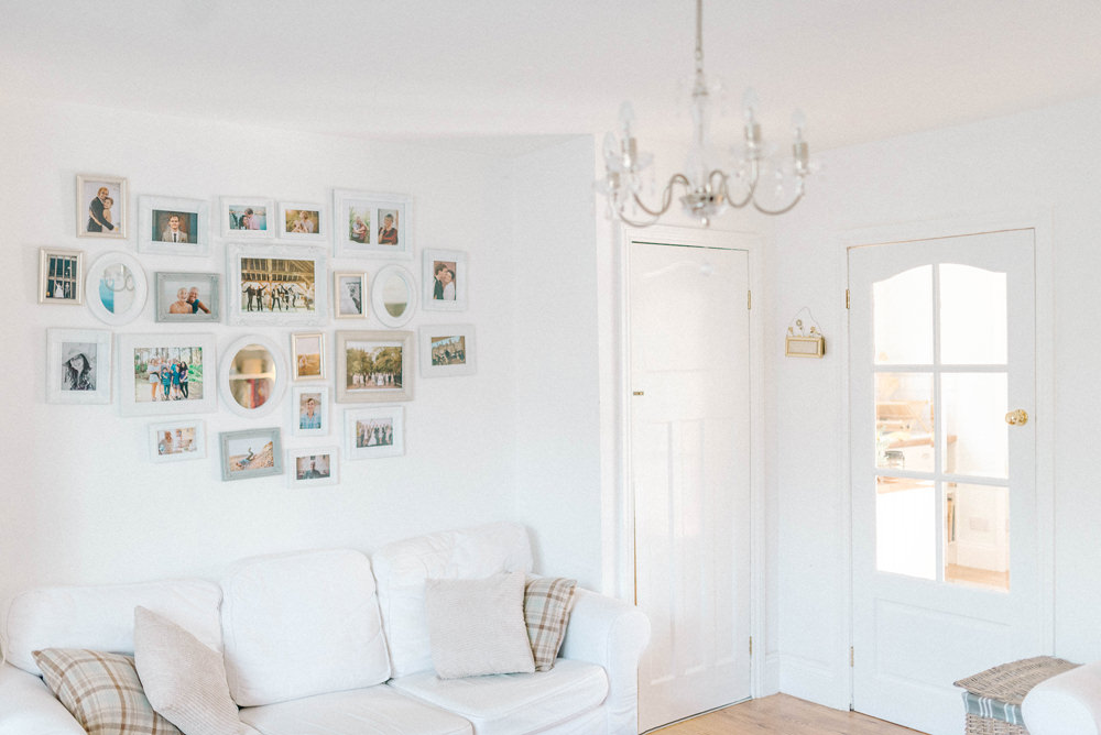 Gallery wall in a bright and light shabby chic style living room
