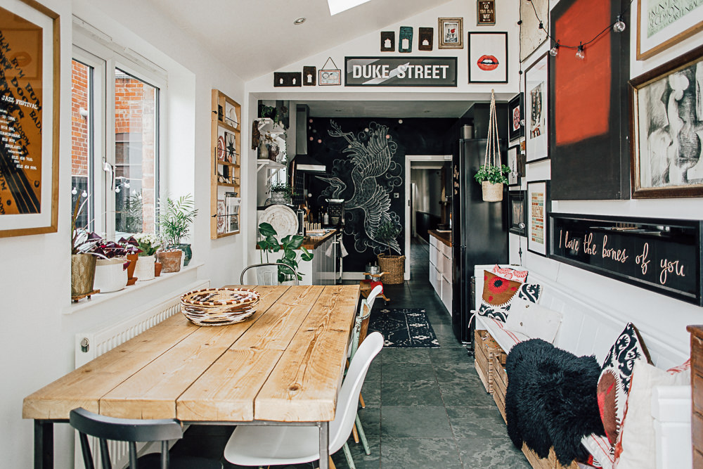 Eclectic kitchen with gallery wall and chalkboard wall