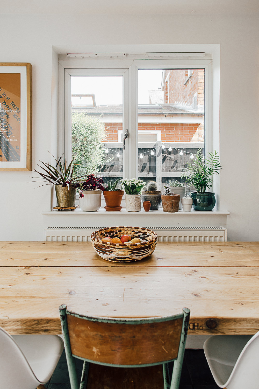 Wooden kitchen table top and planters on window sill