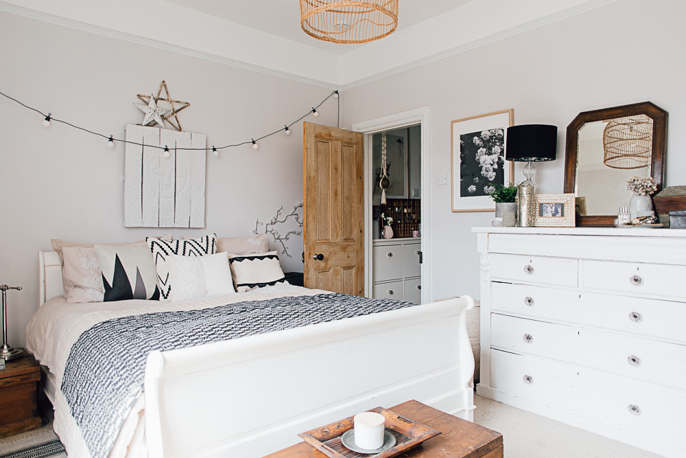 White and neutral boho bedroom with sleigh bed