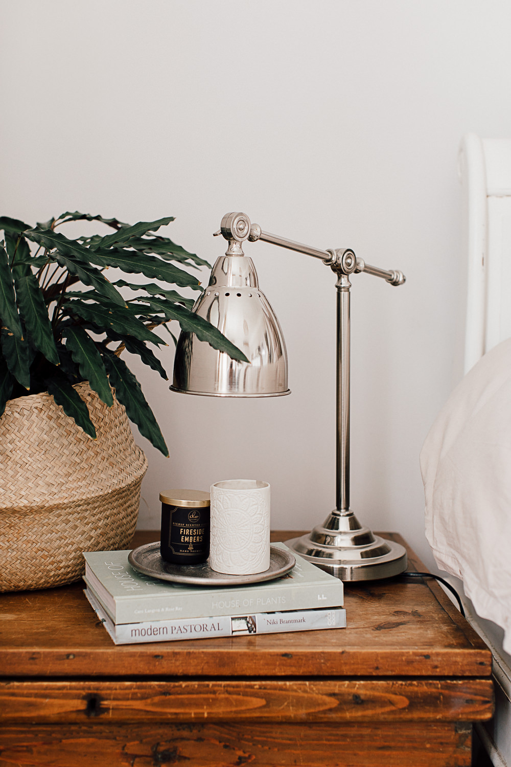 Chrome task lamp and houseplant in basket