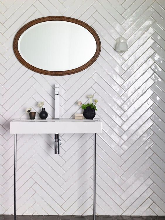 Glossy herringbone bathroom tiles