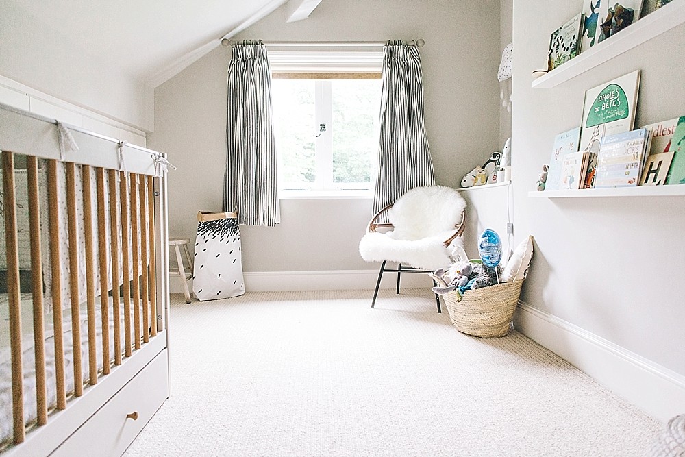 A modern stylish unisex  baby nursery  with a neutral grey 