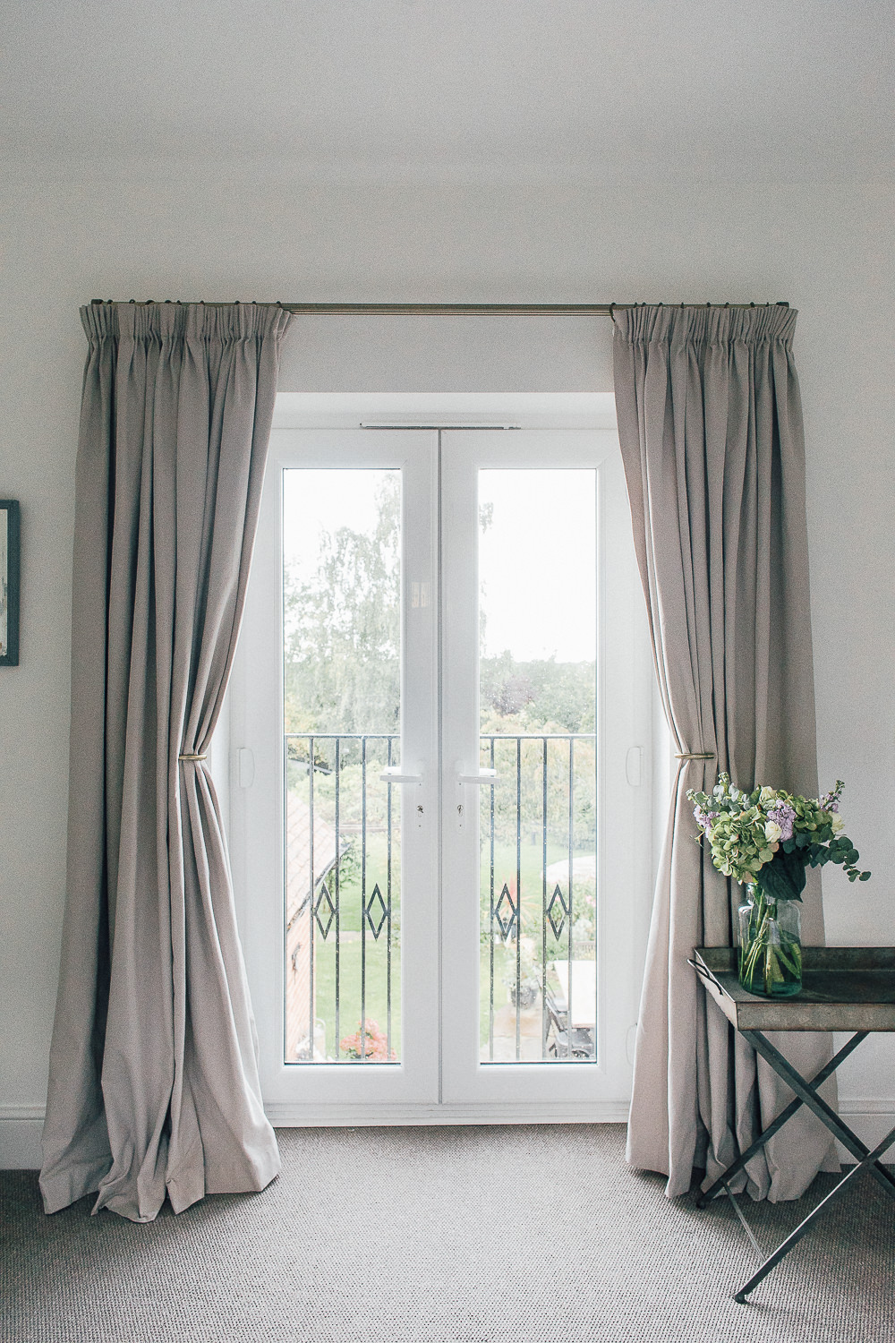 Grey curtains pulled back to let in light