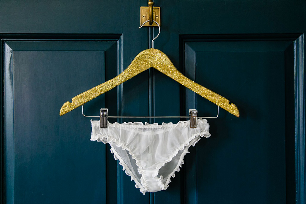 Knickers hung on a dark painted door